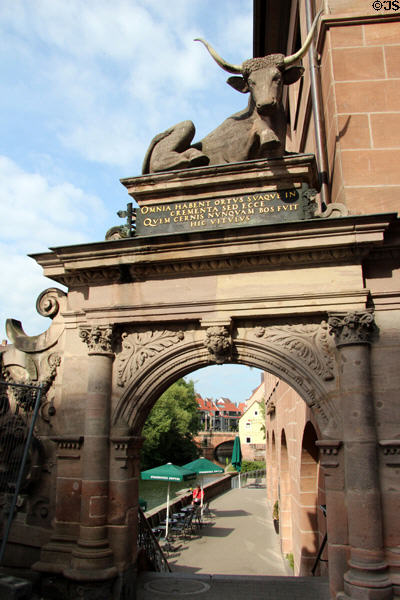 Ox statue (1599) atop portal marks former meat market beside Pegnitz River. Nuremberg, Germany.