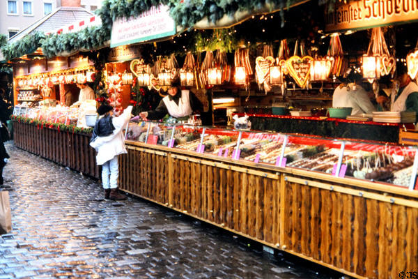 Booth with holiday sweets at Christmas Market on City Hall square. Nuremberg, Germany.