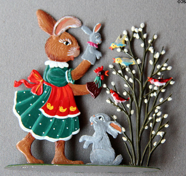 Flat tin rabbit figure with puppets with tree of birds on cast stand from Germany in private collection. Germany.
