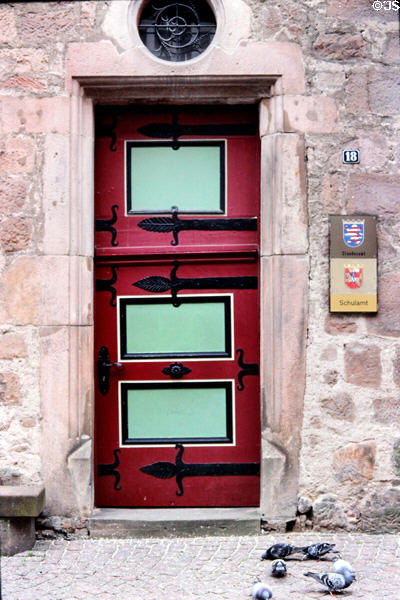 Detail of door on stone house (1323) with Marburg coat of arms along side on marketplace. Marburg, Germany.