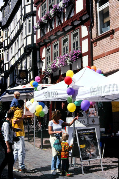 Pedestrians enjoying sunshine on marketplace. Marburg, Germany.