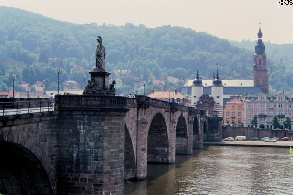 Statuary on Alte Brücke over Neckar River with tower of Heileggeiskirche (Church of the Holy Spirit (1398-1515) in the background. Heidelberg, Germany.