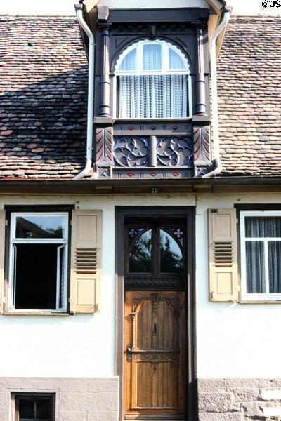Home with tile roof with ornate dormer & carved front door. Hirsau, Germany.