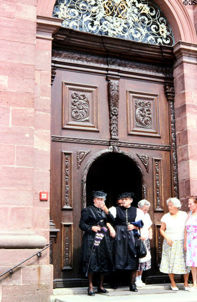 Worshippers in traditional dress leaving Sankt Peter church. Sankt Peter, Germany.