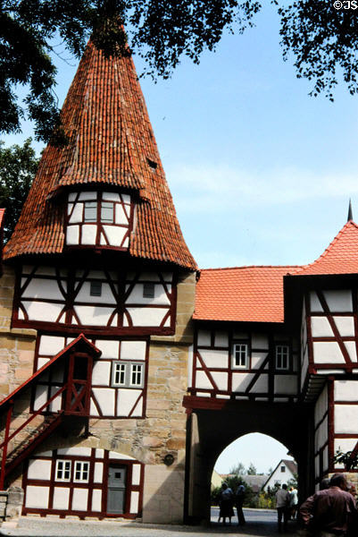 Historic wood framed building with conical tiled roof incorporating a city gate in Bavaria. Germany.