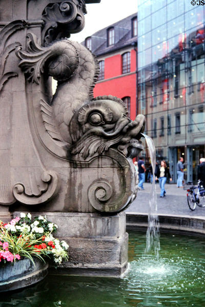 Detail of serpent spitting water on fountain in front of Rathaus (city hall). Würzburg, Germany.