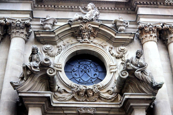 Detail on baroque west façade with skeletons, sometimes used as a reminder of the separation of the earth & the divine, on Neumunster Collegiate Church,. Würzburg, Germany.