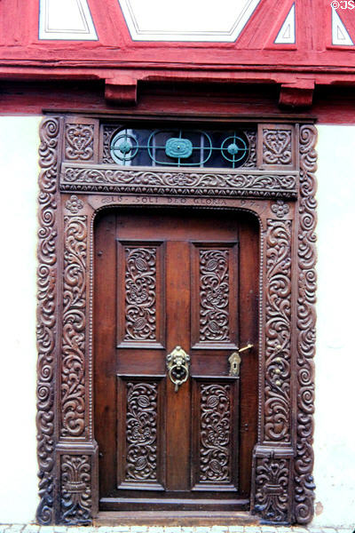 Ornate doorway (1697), with intricate carvings & metal pull on Winter'sches Haus. Nördlingen, Germany.