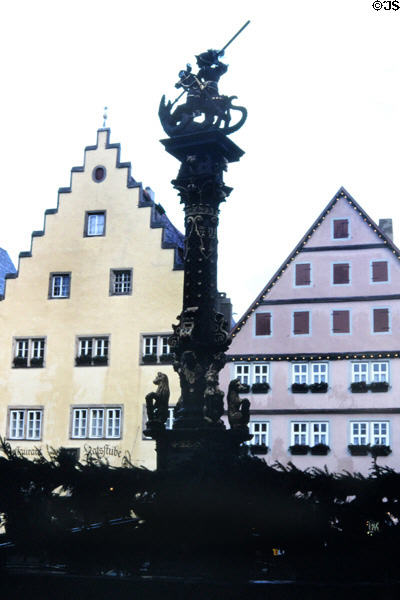 St. George's fountain (1600's), once an important source of drinking water, on market square. Rothenburg ob der Tauber, Germany.