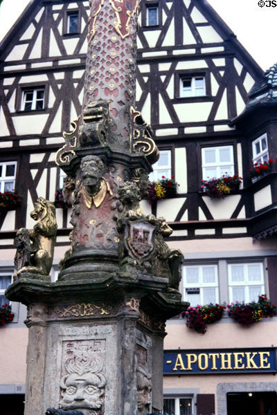 Detail of St. George's fountain (1600's), with Renaissance era column decorations on market square. Rothenburg ob der Tauber, Germany.
