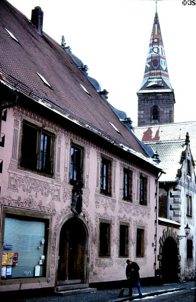 Village with church steeple covered with mosaic tiles in decorative pattern. Wolframs Eschenbach, Germany.