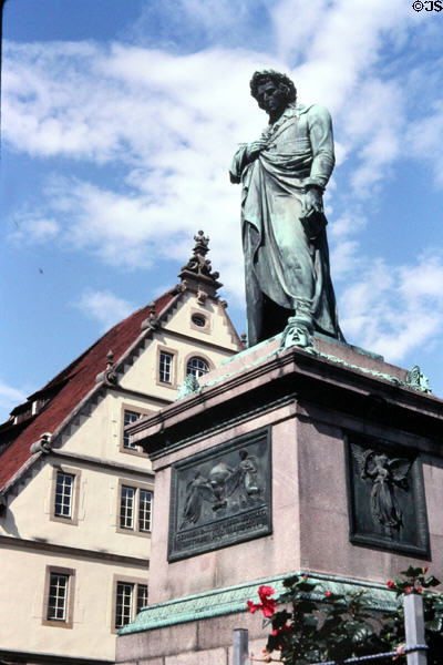 Statue of Friedrich Schiller (1839) by Bertel Thorwaldsen on Schillerplatz with traditional steep roofed building in background. Stuttgart, Germany.