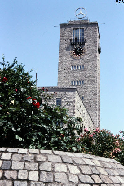 Brick clock tower of railway station with Mercedes emblem on top. Stuttgart, Germany.