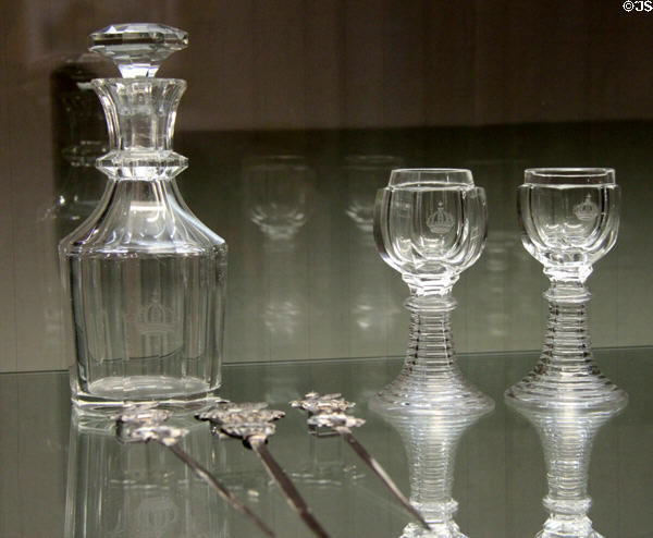 Set of glasses & carafe with crown emblem (latter half 19thC) manufactured by Theresienthal & silver "lark skewers" (1865) made by Louis Rappolt at King Ludwig II Museum. Chiemsee, Germany.