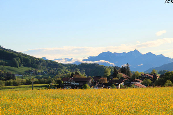 View over fields to mountains in the distance in Chiemsee region. Chiemsee, Germany.