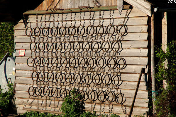 Antique chain field leveling device used as trellis on farm building in Chiemsee region. Chiemsee, Germany.