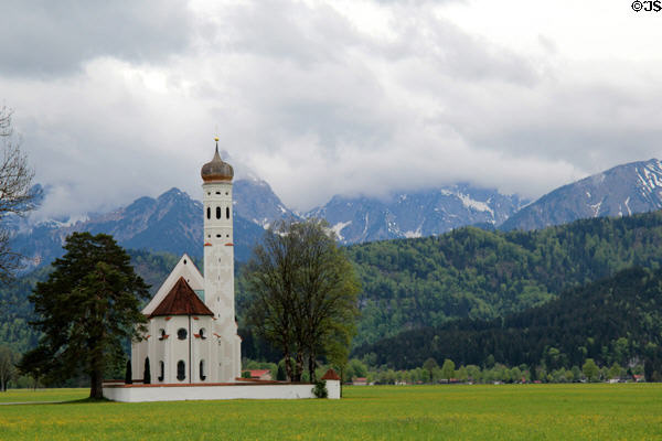 St Coloman baroque church (17thC) in Schwangau in pastoral setting with Alps in background. Füssen, Germany.