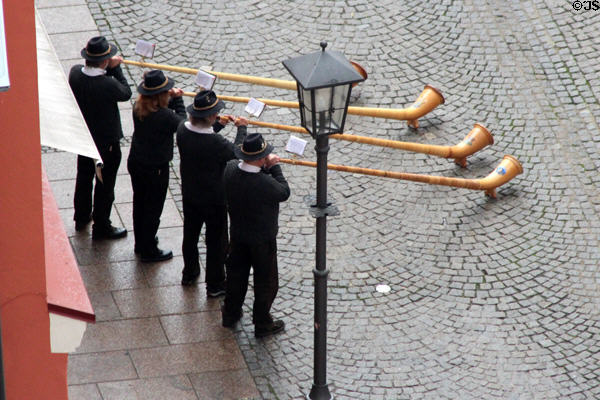 Men playing Alphorns on street. Füssen, Germany.