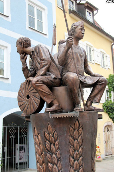 Brotbrunnen with baker & miller with his millstone on Schranenngasse in town center. Füssen, Germany.