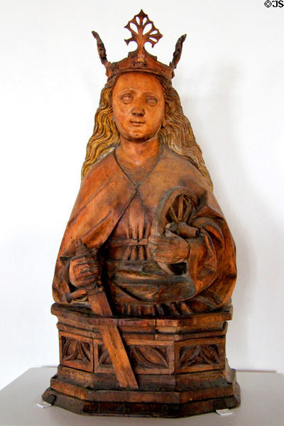 Wood carving of St Catherine martyr (1498), with her attributes, a wheel & a sword by Meister of Imberger Altars in State Gallery at Hohes Schloss zu Füssen. Füssen, Germany.