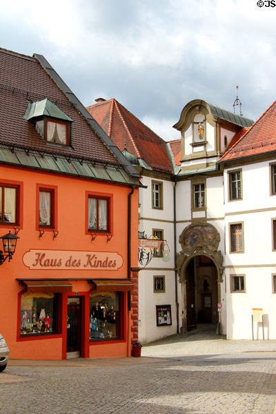 Traditional shop selling children's wear next to entrance to City Museum located within Kloster St Mang. Füssen, Germany.