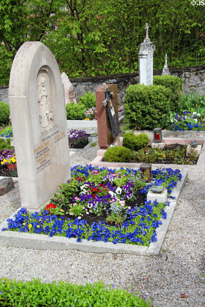 Tombstone & planted flowers in cemetery of St Aegidius parish church. Gmund am Tegernsee, Germany.