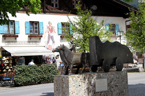 Horses & wagon commemorating Rott Strasse trade route, former Red Road between Venice & Augsburg which flourished during 15th & 16th C, bronze sculpture (2000) by Hubert Langmain. In Oberammergau goods were loaded on smaller carts destined for surrounding villages. Oberammergau, Germany.
