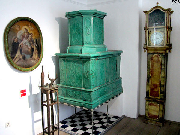 Tiled heating stove & painted tall clock (late 18thC - early 19thC) by Georg Lang at Oberammergau Museum. Oberammergau, Germany.