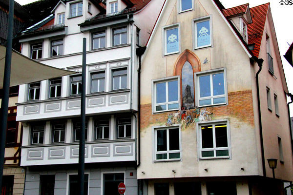 Ulmer Museum buildings lining Marktplatz with historical mural. Ulm, Germany.