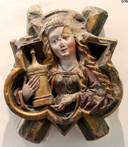 Keystone with sculpture of St Mary Magdalene (1490) holding her symbol of covered ointment jar by unknown artist from Kloster Blaubeuren at Ulmer Museum. Ulm, Germany.