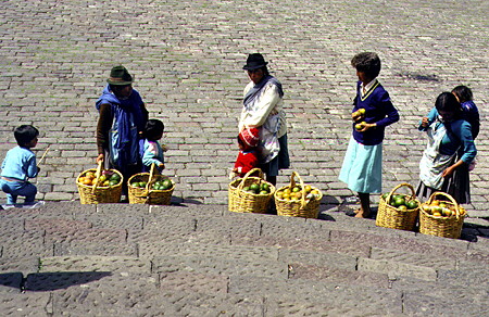 Fruit sellers in San Francisco Monastery cobblestoned square in Quito. Ecuador.