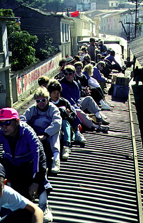 Passengers riding on the roof of the cars of the steam train departing Alausí for Guayaquil. Ecuador.