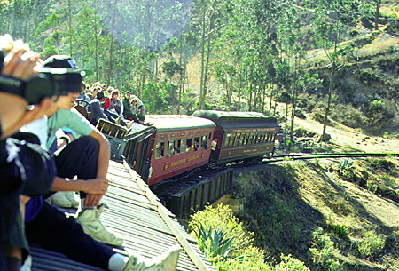 Tourists riding the roof of the steam train bound for Guayaquil. Ecuador.