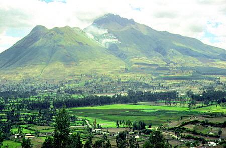 Scenic view of volcanoes and green fields on the way to Otavalo north of Quito. Ecuador.