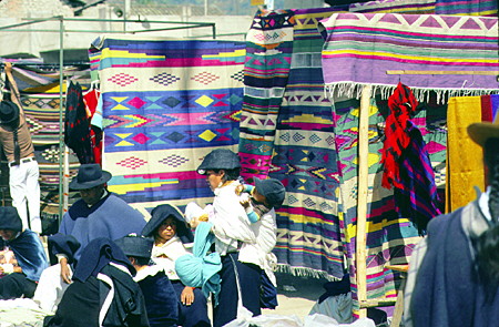 Woven blankets on display in the market at Otavalo. Ecuador.