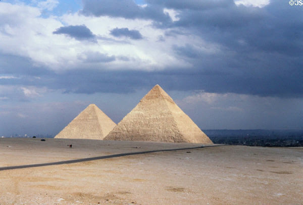 Pyramids of Cheops (137.2m height) & Chephren (136.5m) (4th dynasty c2575-2465 BCE) in brilliant sun before storm. Giza, Egypt.
