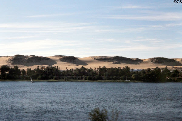 View of the Nile & sand dunes on opposite bank along road to Aswan. Egypt.