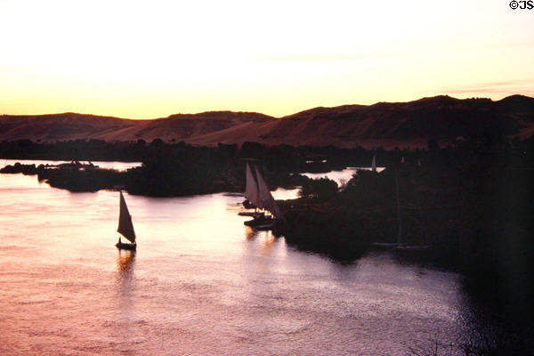 Traditional Felucca sailboats at dusk on Nile River at Aswan. Egypt.