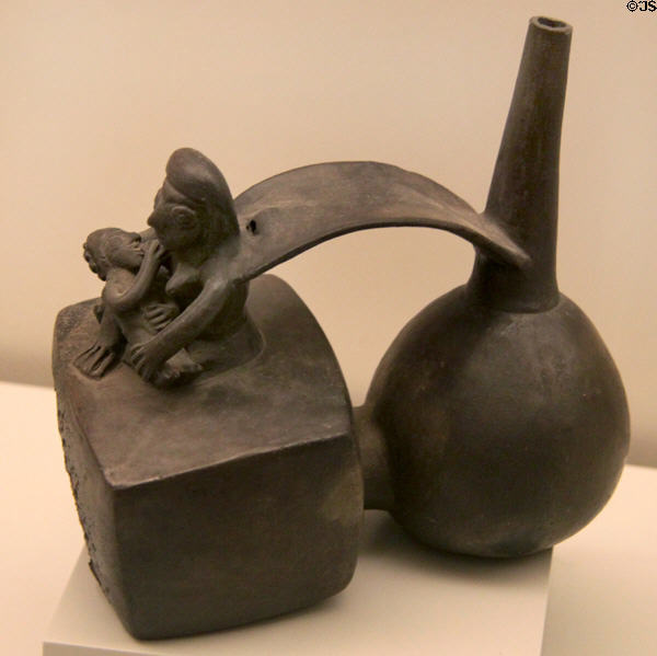 Chimu culture ceramic stirrup-spout bottle with mother nursing her child (1100-1450) from Peru at Museum of America. Madrid, Spain.