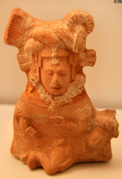 Mayan ceramic sitting female with knotted headdress (600-900 CE) from Mexico at Museum of America. Madrid, Spain.