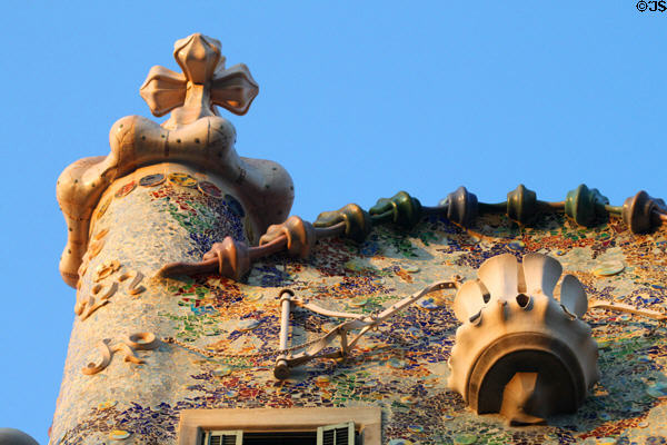 Gaudi's signature cross, curves & tile mosaics on Casa Batlló. Barcelona, Spain.