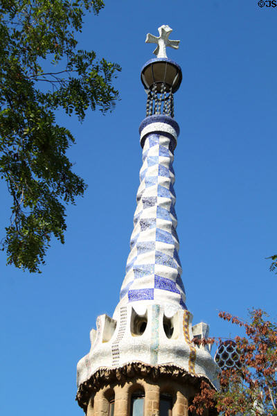 Tower of reception pavilion with Gaudí's signature square cross on top at Parc Güell. Barcelona, Spain.