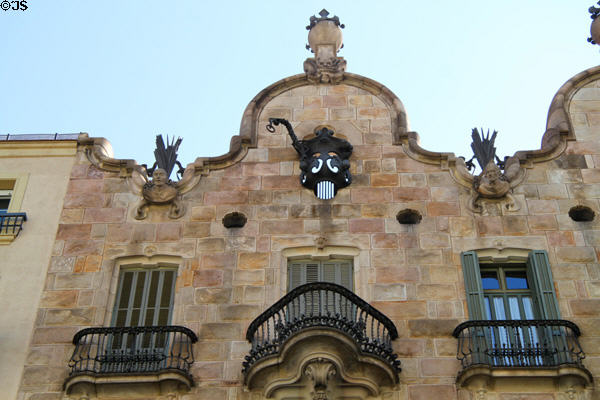Gable with owner's family sculptures & Gaudí's ironwork designs atop Casa Calvet. Barcelona, Spain.