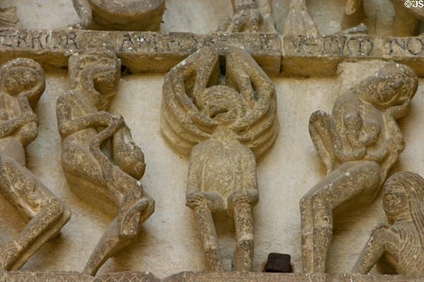Detail of sole being plucked into Hell at Last Judgment on tympanum of Cathedral St. Lazarre. Autun, France.