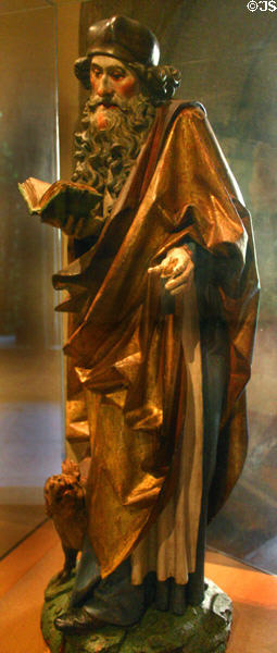 Wooden statue of St Anthony the Great with pig at his feet (c1500) from upper Rhine in Unterlinden Museum. Colmar, France.