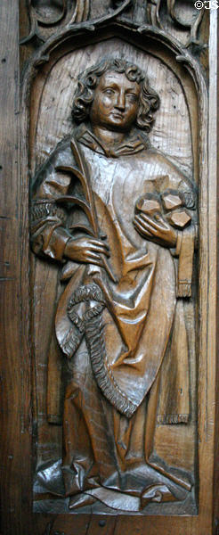 Oak choir stall (1493) carved with St. Stephen (with stones of his stoning) in Unterlinden Museum. Colmar, France.