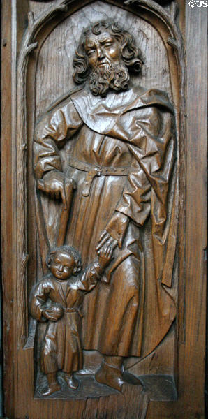 Oak choir stall (1493) carved with St Joseph or St Christopher & Christ child in Unterlinden Museum. Colmar, France.