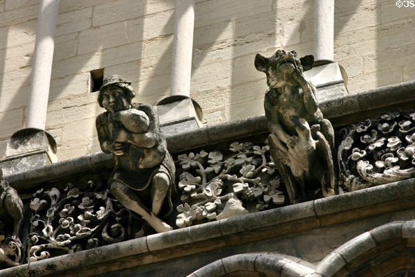 Bagpiper & cow gargoyles on Notre Dame church. Dijon, France.