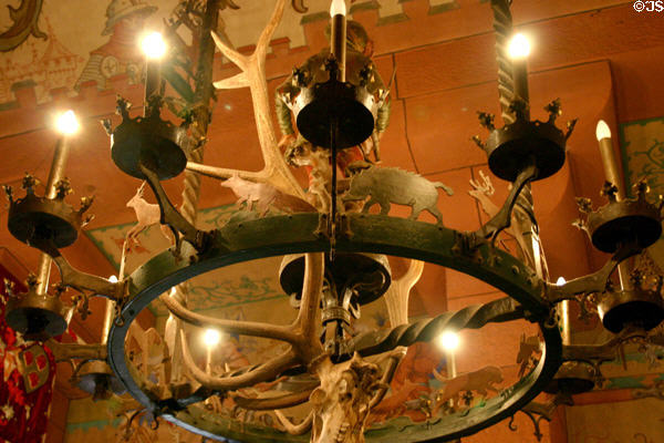 Chandelier with antlers & game profiles in Haut Koenigsbourg. France.