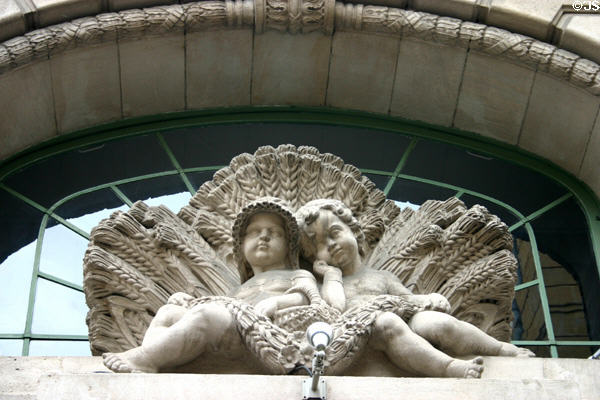 Germanic empire-style sculpture (c1914) features cherubs with wheat. Metz, France.